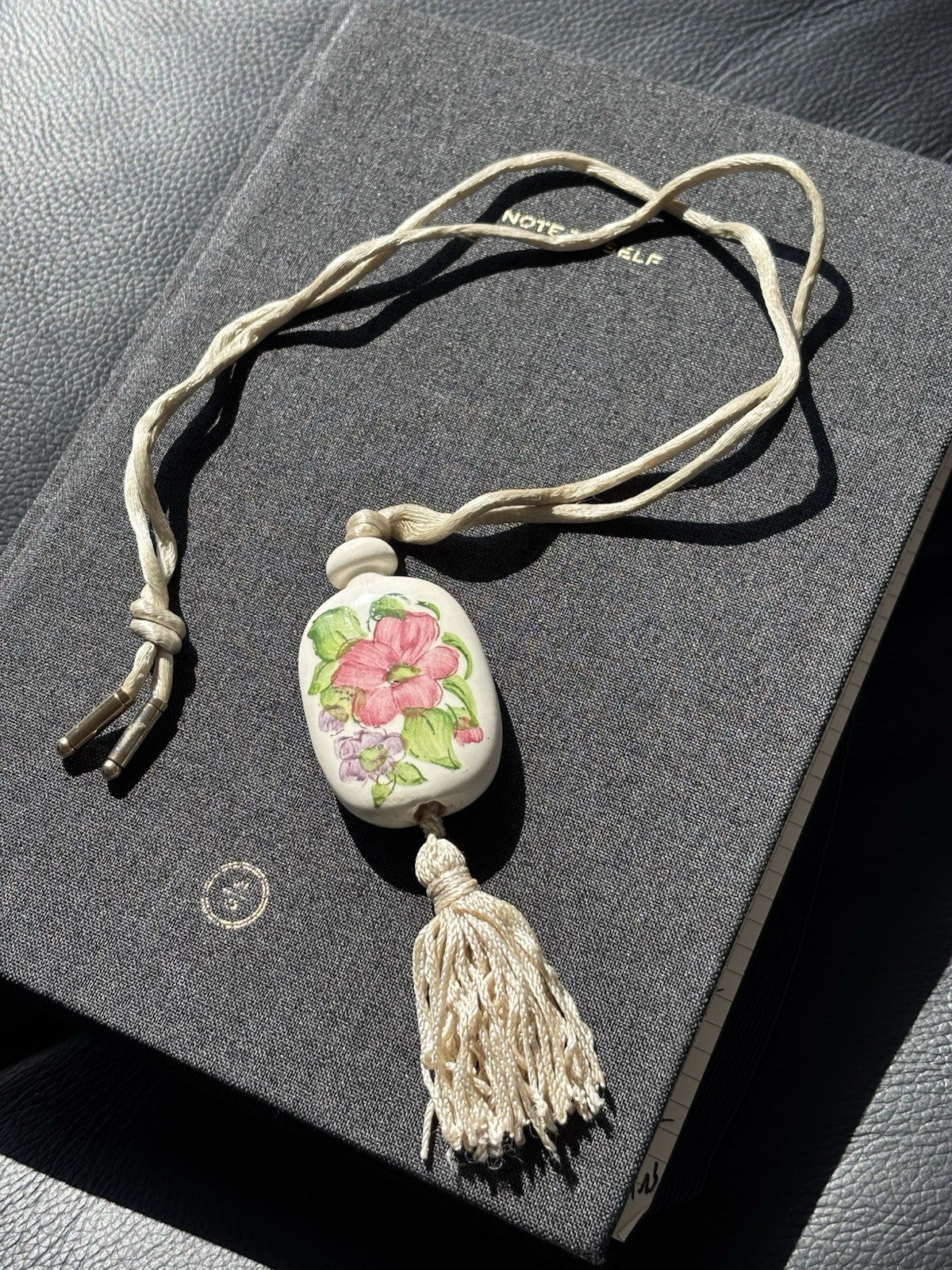 Vtg AVON Hand Painted Floral Ceramic Pendant Necklace W/Tassel & Silk Cord 1980